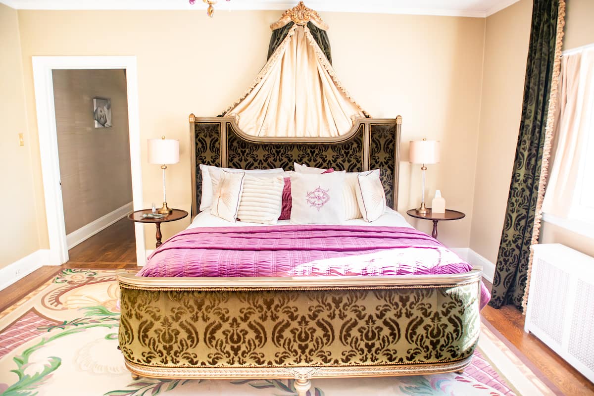 French bedroom with gold damask bed and pink bedding