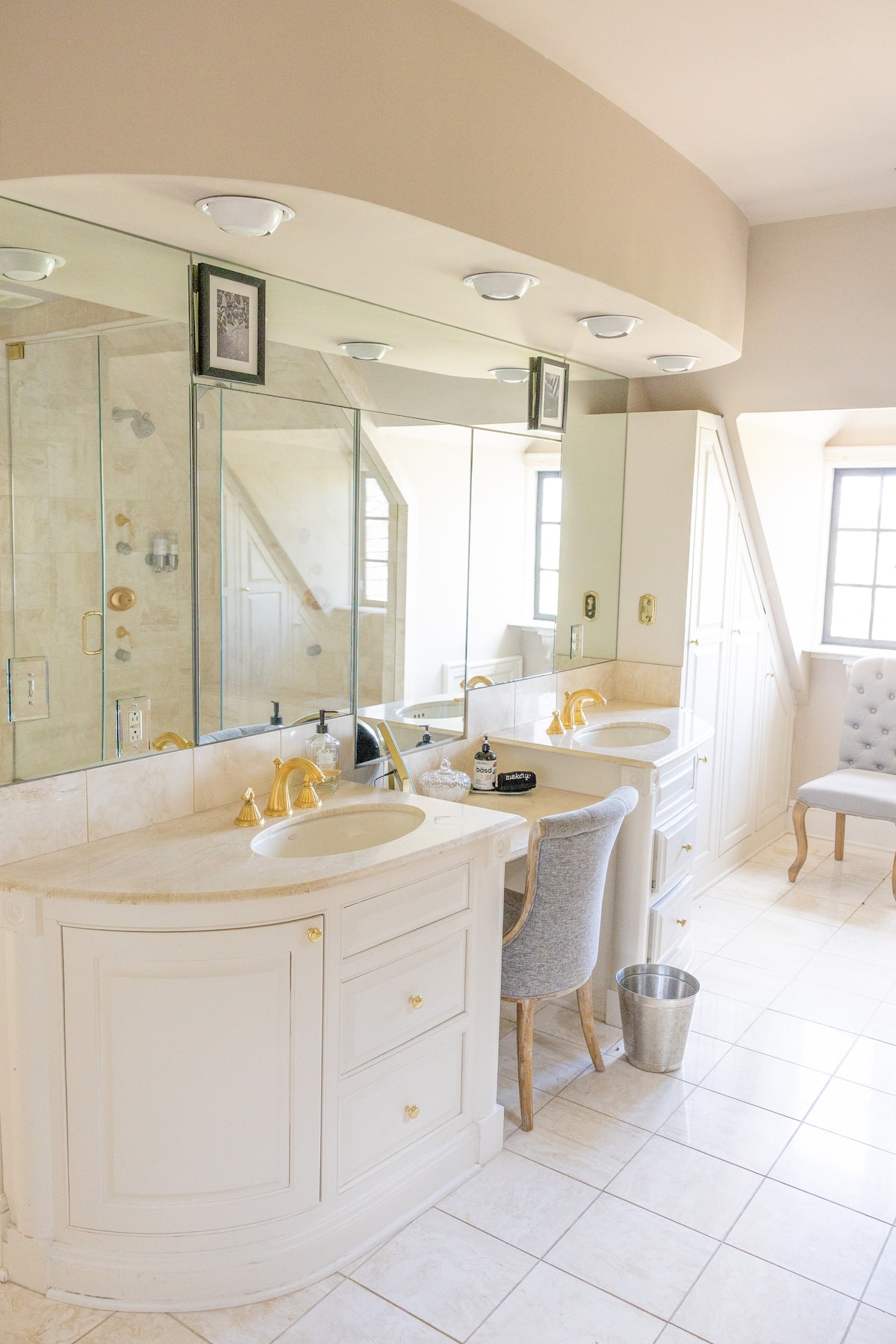 Spa bathroom with raised jetted tub and skylight chandelier