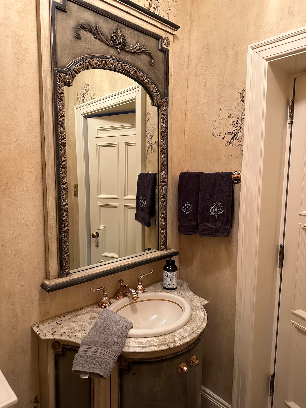 Tuscan-style powder room with stenciled walls