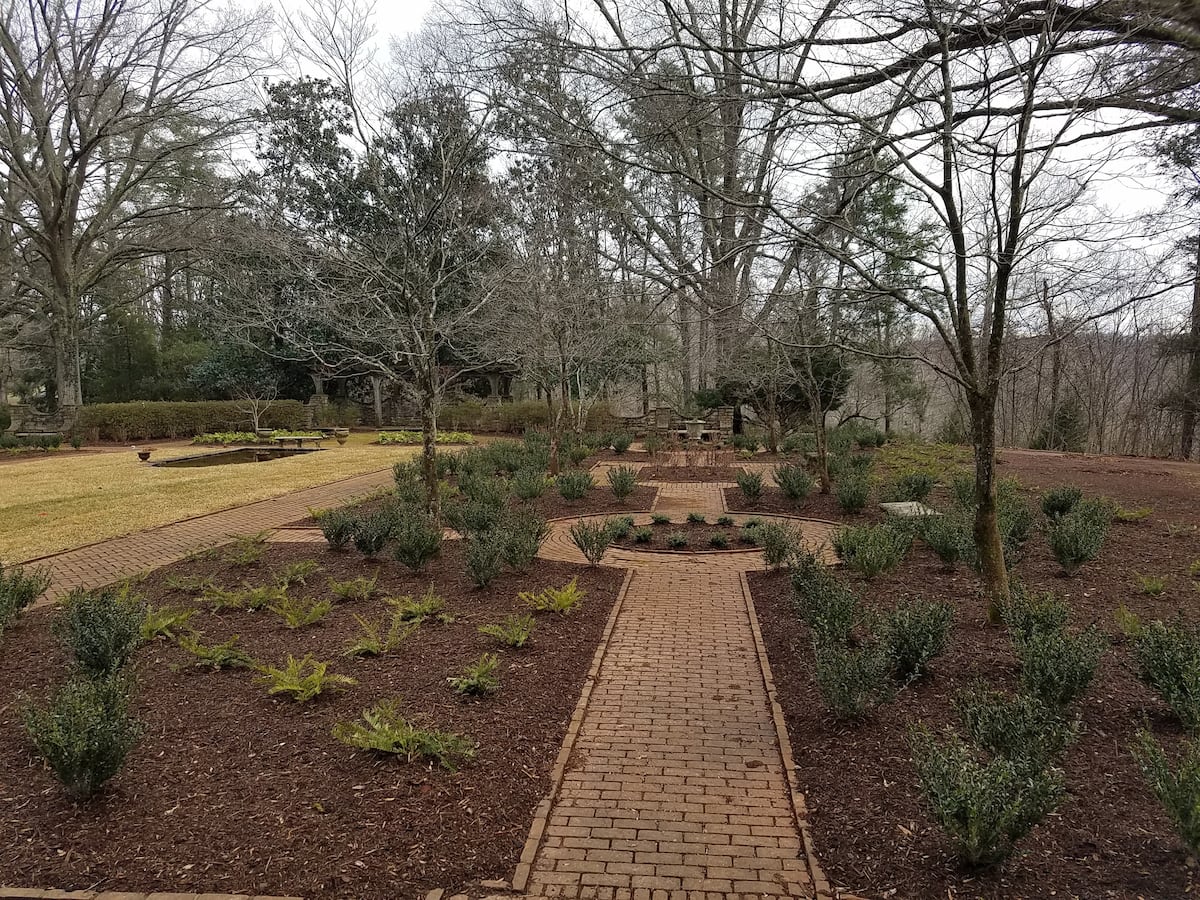 Formal brick pathway through dormant winter garden