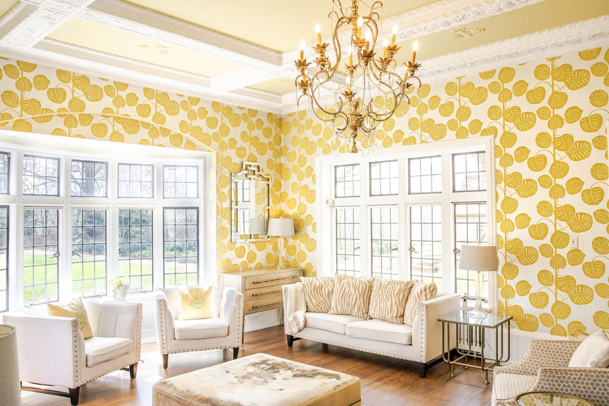Sunroom with yellow leaf wallpaper and crystal chandelier