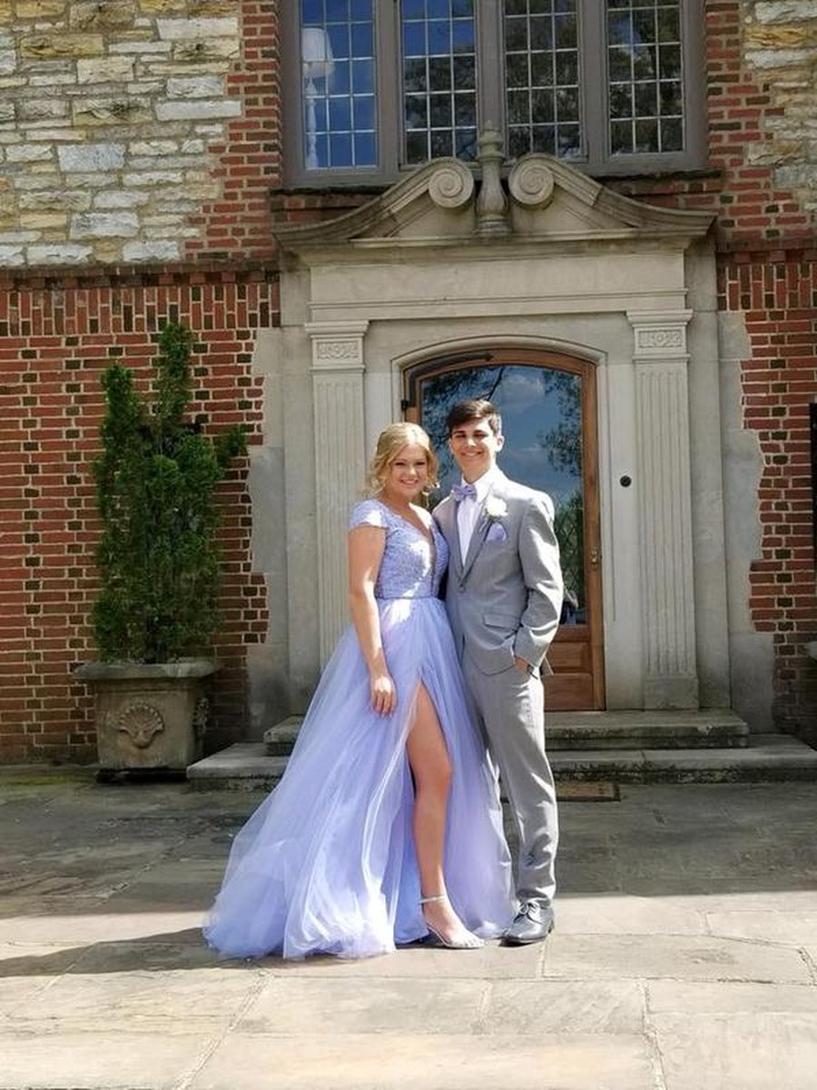 Couple standing in front of ornate brick and stone mansion entrance